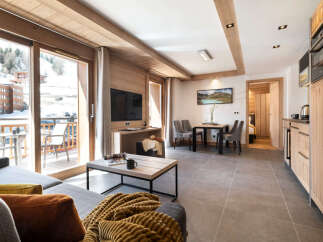 This stunning apartment boasts a spacious living area with floor-to-ceiling windows offering breathtaking mountain views, a fully equipped kitchen, and modern amenities.