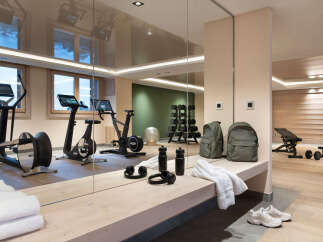 This stunning gym boasts state-of-the-art equipment, including stationary bikes and elliptical trainers, perfect for a challenging workout.