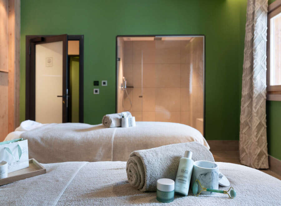 Indulge in ultimate relaxation at our luxurious spa, featuring plush massage tables, a tranquil shower, and premium skincare products.
