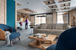 Relax in our stylish lobby, featuring comfortable seating, a coffee table with magazines, and a modern reception desk.