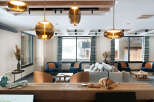 This stunning lobby boasts a cozy and inviting atmosphere, featuring plush seating arrangements and stylish pendant lights.