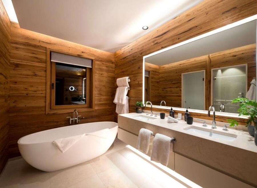 Experience luxury in this stunning bathroom featuring a modern design with a touch of nature.
