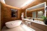 Experience luxury in this stunning bathroom featuring a modern design with a touch of nature.