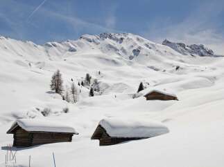 Experience the serene beauty of a snow-covered mountain landscape.