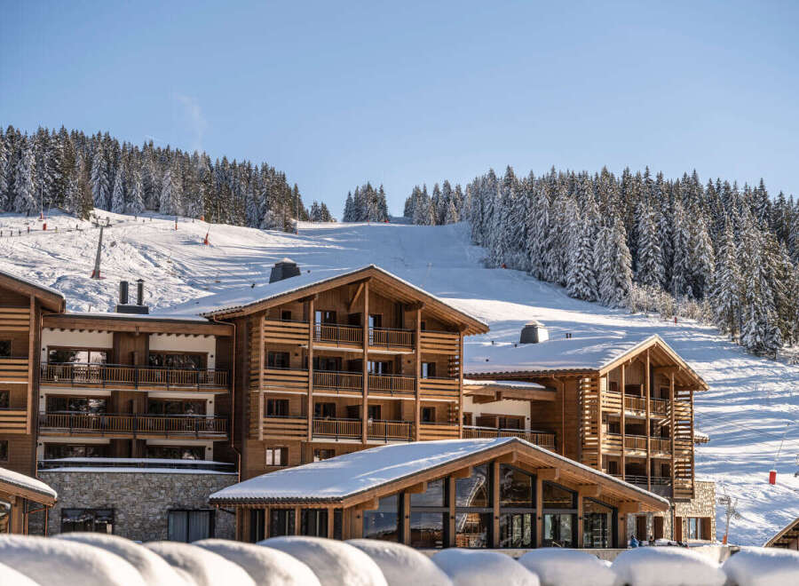 Luxury chalet-style hotel nestled in a stunning snow-covered mountain setting.