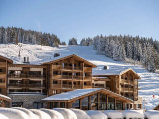 Luxury chalet-style hotel nestled in a stunning snow-covered mountain setting.