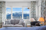 Luxury mountain view room with a comfortable couch and stylish lamps.