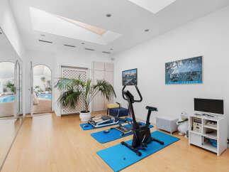 This stunning home boasts a luxurious indoor gym, complete with state-of-the-art equipment and a tranquil atmosphere.