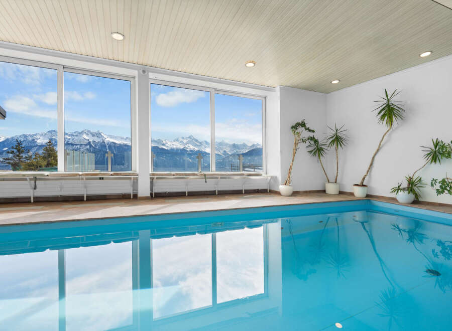 Indoor pool with stunning mountain views.