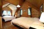 Cozy cabin with two bedrooms, each featuring a comfortable double bed and crisp white linens.