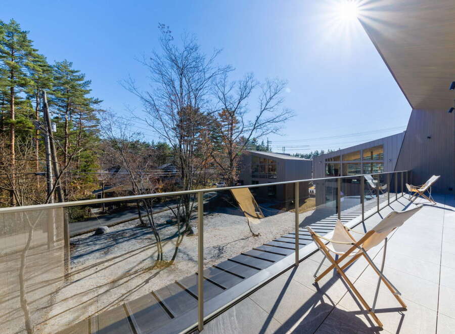 Modern balcony overlooking serene forest views.