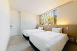 Wake up to stunning views of nature from this cozy twin bedroom.