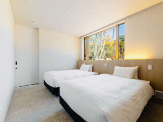Wake up to stunning views of nature from this cozy twin bedroom.