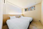 Wake up to stunning forest views from this cozy twin bedroom.