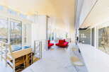 Stunning modern home with open floor plan, showcasing a sleek marble floor and large windows offering abundant natural light.