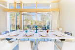 Modern dining room with large windows offering scenic views.