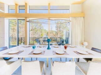 Modern dining room with large windows offering scenic views.