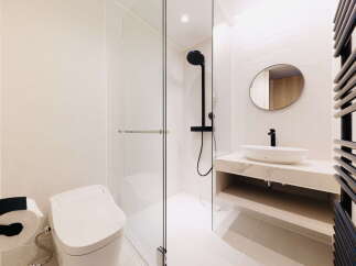 Modern bathroom with hexagonal tiles, walk-in shower, and floating vanity.