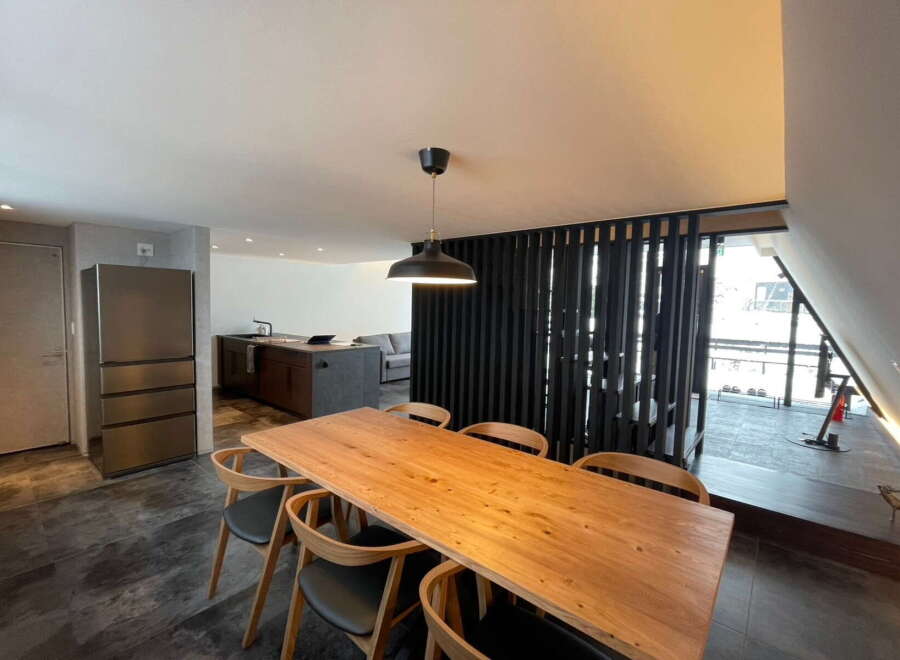 This stunning property boasts a spacious open-plan living area with a sleek modern kitchen and a large dining table perfect for entertaining.