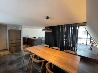 This stunning property boasts a spacious open-plan living area with a sleek modern kitchen and a large dining table perfect for entertaining.