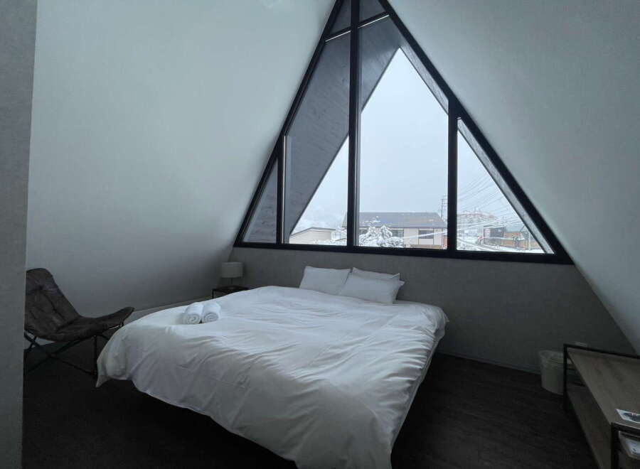 Wake up to stunning views from this A-frame cabin's triangular window.
