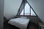 Wake up to stunning views from this A-frame cabin's triangular window.