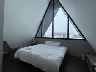 Wake up to stunning views from this A-frame cabin's triangular window.