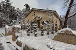 This stunning property boasts a unique stone exterior, perfectly complementing its snowy surroundings.