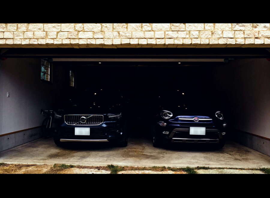 Park your cars in this spacious two-car garage, featuring a modern design and convenient storage.