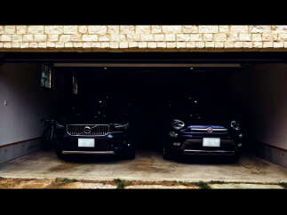Park your cars in this spacious two-car garage, featuring a modern design and convenient storage.
