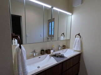 This stunning bathroom boasts a double vanity with sleek, modern sinks and ample counter space.