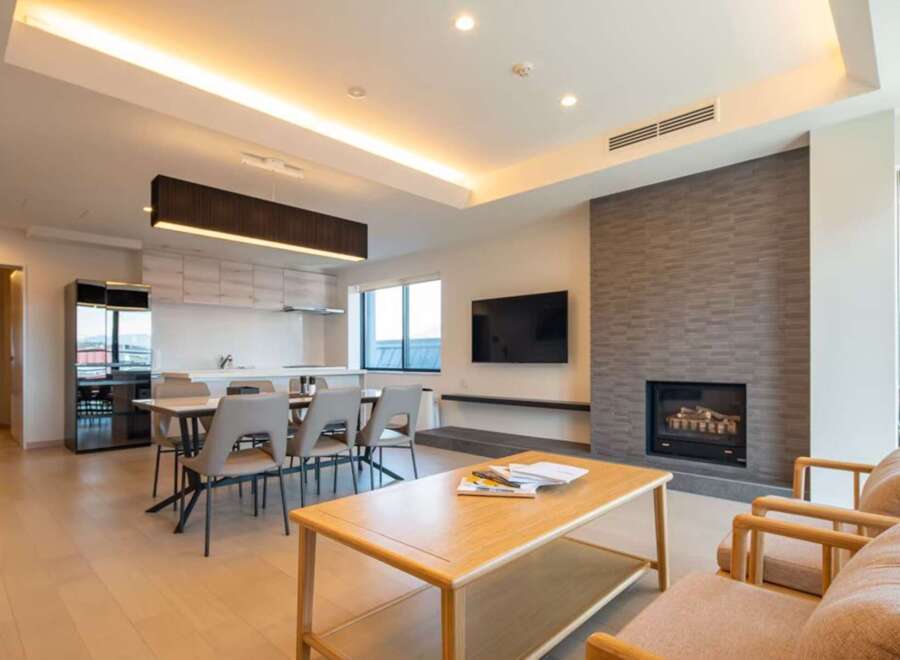 This stunning property boasts an open-concept living area with a modern kitchen and dining space, perfect for entertaining.