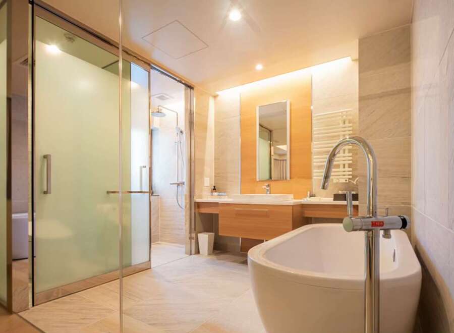 Luxurious bathroom with a freestanding bathtub and a walk-in shower, featuring modern fixtures and elegant design.