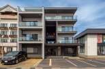 This stunning modern building boasts four floors of luxury apartments, each with its own private balcony.