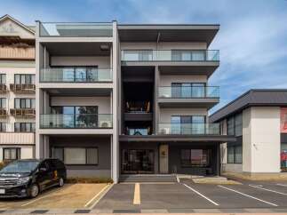 This stunning modern building boasts four floors of luxury apartments, each with its own private balcony.