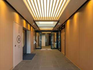 This stunning property boasts a sophisticated entrance with a sleek, modern design.