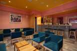 Stylish lounge area with teal armchairs and a comfortable sofa, perfect for relaxing after a day of skiing.
