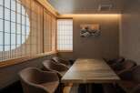 This exquisite dining room boasts a serene ambiance, highlighted by stunning shoji screens and a captivating Great Wave artwork.
