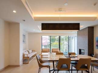 This stunning modern home boasts an open floor plan, seamlessly connecting the living and dining areas.