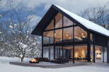 Stunning modern A-frame home nestled in a snowy winter wonderland.