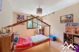 Charming child's bedroom with a wooden bed frame and built-in shelving.