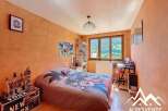 Charming bedroom with mountain views, featuring a comfortable bed and a dedicated workspace.