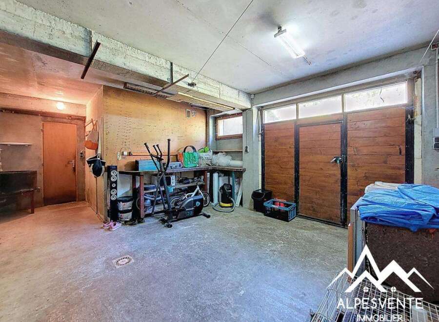 Spacious garage with ample storage, workbench, and room for multiple vehicles.