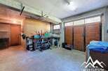 Spacious garage with ample storage, workbench, and room for multiple vehicles.
