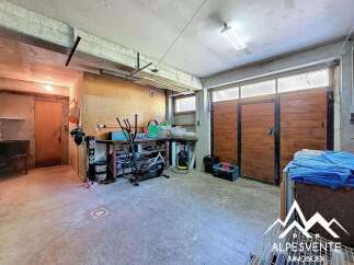 Spacious garage with ample storage, workbench, and room for multiple vehicles.