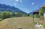 Mountain view property with a spacious yard perfect for kids, featuring a swing set and ample room for outdoor activities.