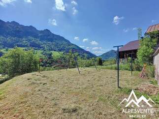 Mountain view property with a spacious yard perfect for kids, featuring a swing set and ample room for outdoor activities.