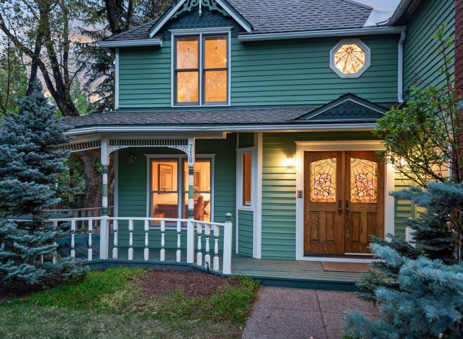 Charming Victorian home with a wrap-around porch and beautiful stained-glass details.