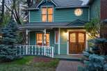 Charming Victorian home with a wrap-around porch and beautiful stained-glass details.