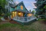 This charming green house boasts a spacious wrap-around porch, perfect for enjoying evenings outdoors.